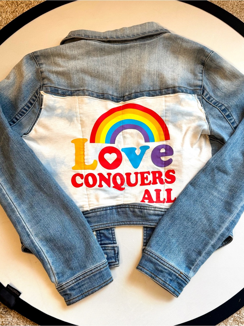 Cropped Light Blue Denim Jacket with Rainbow 'Love Conquers All' Back Panel